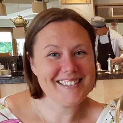 Woman with dark hair in a bob. She is smiling.