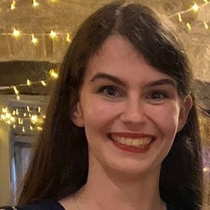 Jenny 2 Woman with long dark hair, she is smiling.