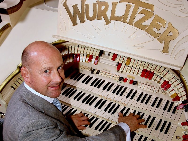 A man playing a Wurlitzer organ