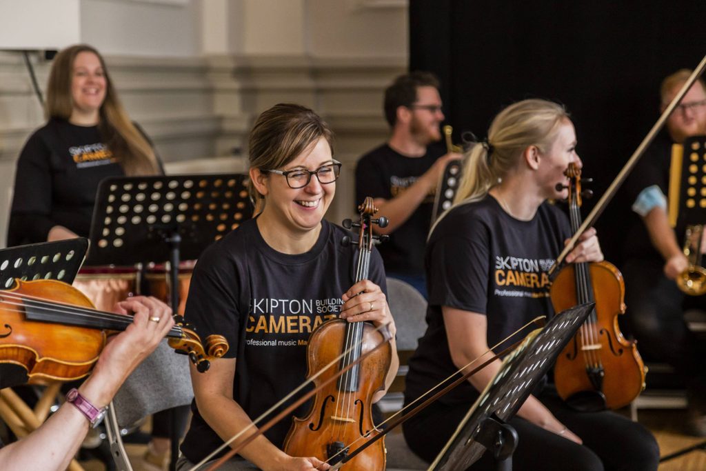 Members of an orchestra with string instruments