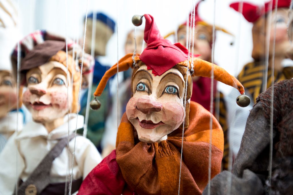 Carved wooden puppets dressed as jesters