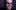 Colin Manford A man with dark hair and glasses with his hand over his mouth