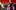 ab9696d8-c578-407e-a90c-edfdc63b3b7b A man and a woman performing in front of red curtain
